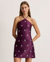 Plum Bree Dress with halter neck and floral embellishments on a model